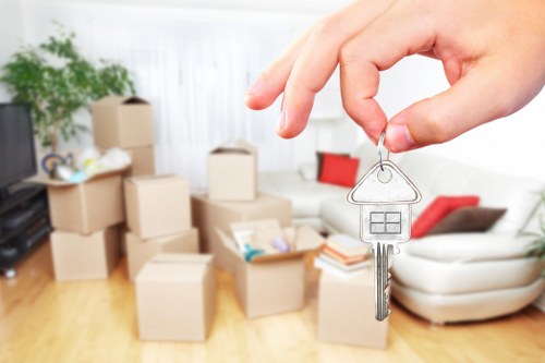 Professional packers handling fragile household items in South Kensington