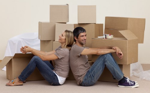 Packed boxes and furniture ready for transport with a moving van