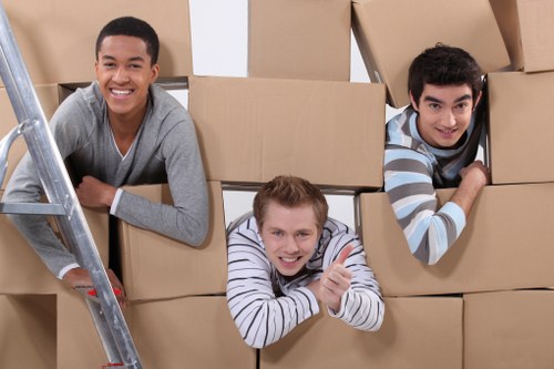 Mover wearing PPE while carrying furniture carefully