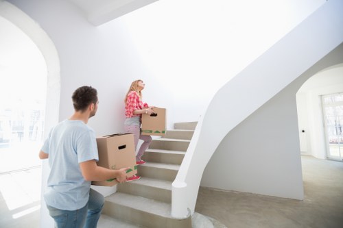 Removal professionals navigating a tight access point in South Kensington