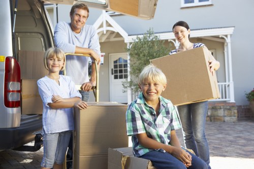 Staff handling packed boxes with care during a removals job