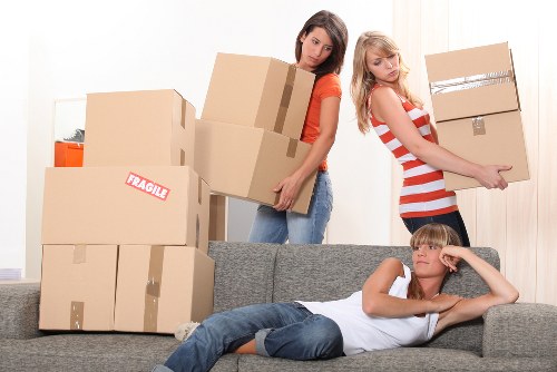 Removal team handling boxes and furniture in a South Kensington flat